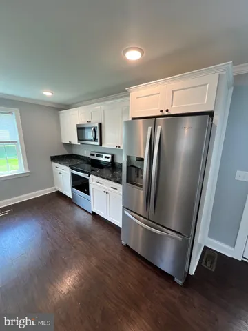 a kitchen with stainless steel appliances a refrigerator and a stove top oven