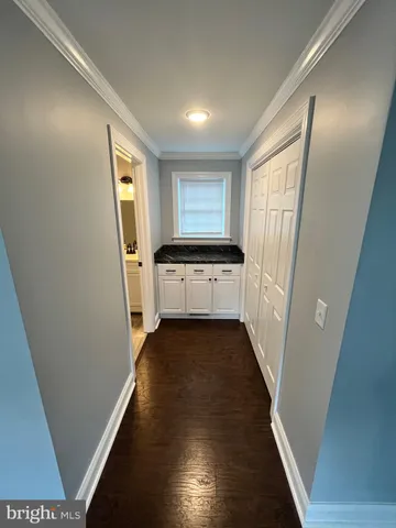 a view of a kitchen from a hallway