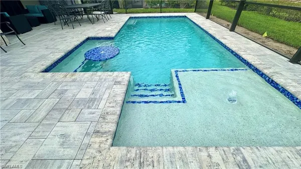 a view of a patio with table and chairs under an umbrella