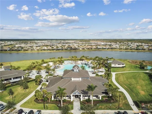 a living room with furniture a chandelier and a large window