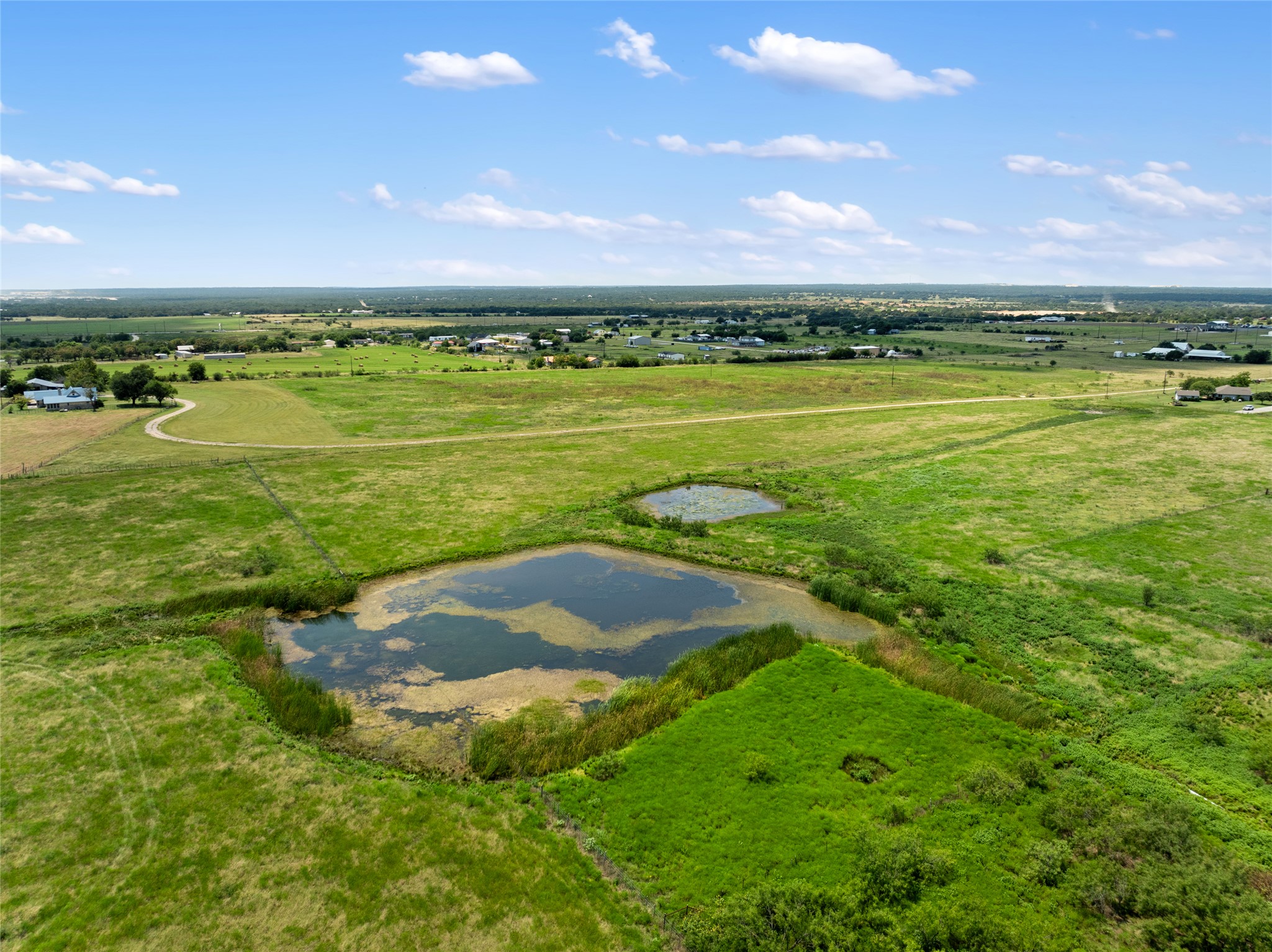 1775 County Road 305 Jarrell, TX 76537 - Photo 5 of 11 Aerial view of sparsely populated area featuring a large body of water