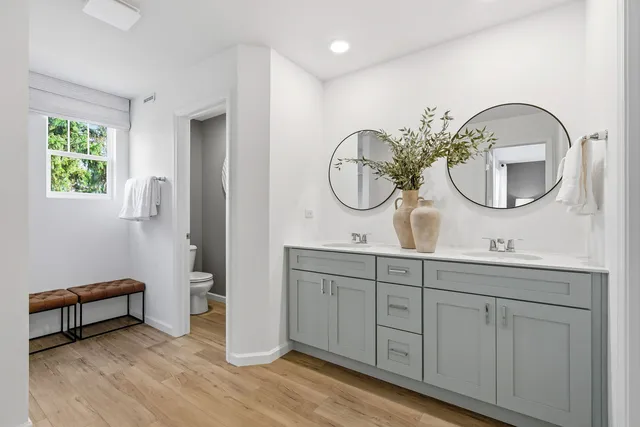 a bathroom with a double vanity sink and a mirror