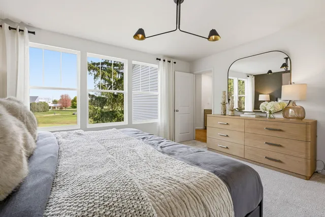 a bedroom with a bed and a dresser