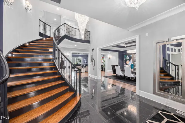 a kitchen with stainless steel appliances kitchen island granite countertop a table chairs sink and cabinets