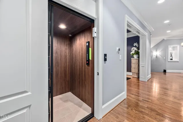 a spacious bedroom with a bed and a chandelier