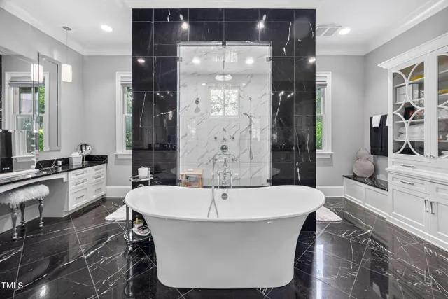 a bathroom with a granite countertop sink toilet mirror and shower