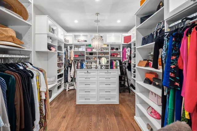 a bathroom with a double vanity sink a toilet and a large mirror
