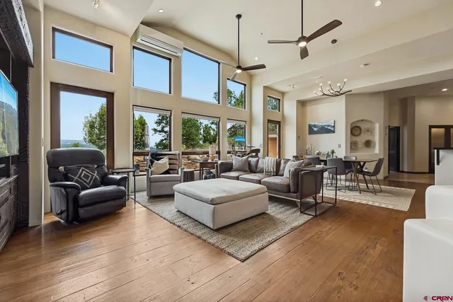a living room with furniture ceiling fan and a window