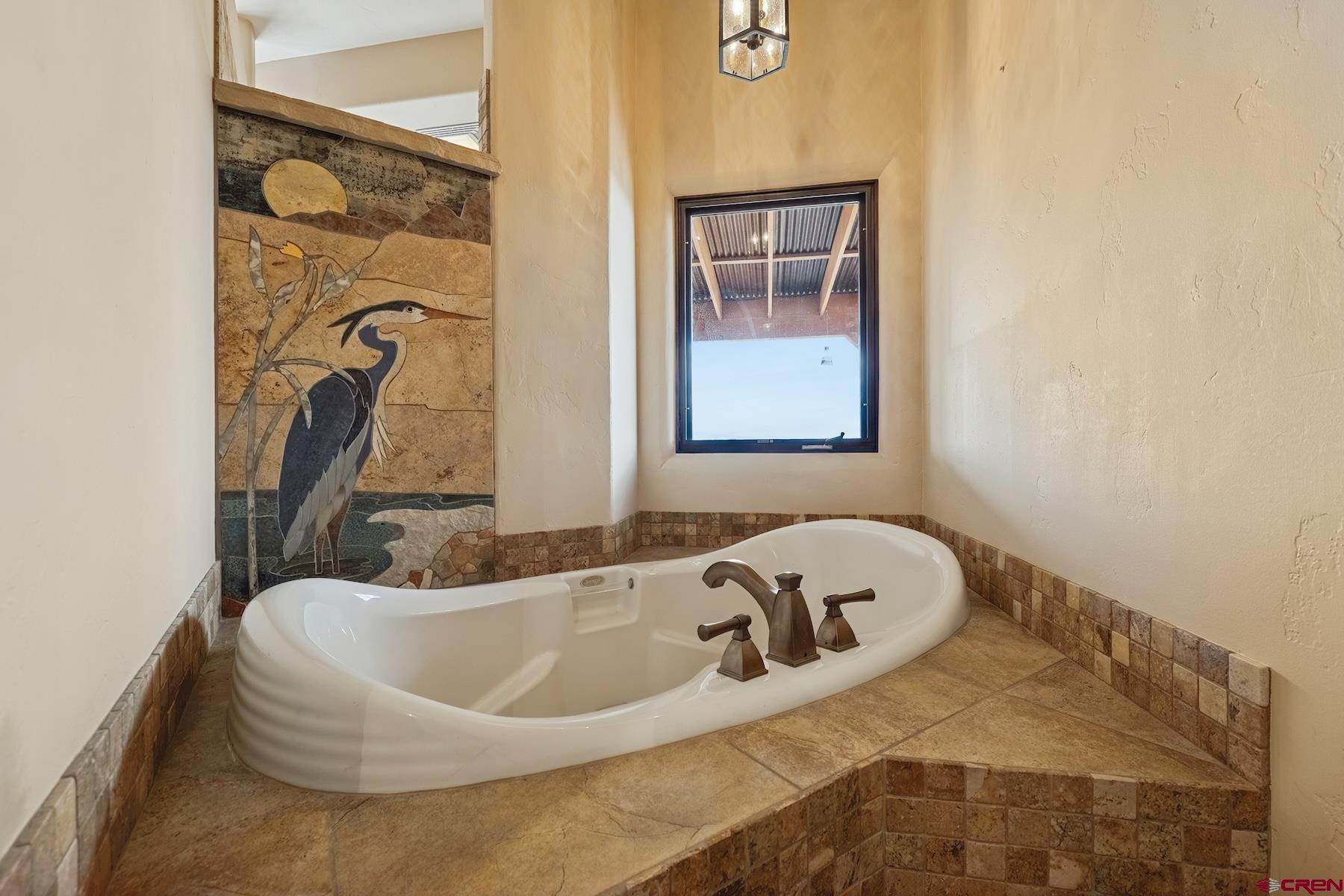 191 Deer Valley Road Hesperus, CO 81326 - Photo 22 of 45 a bath tub sitting in a bathroom next to a window