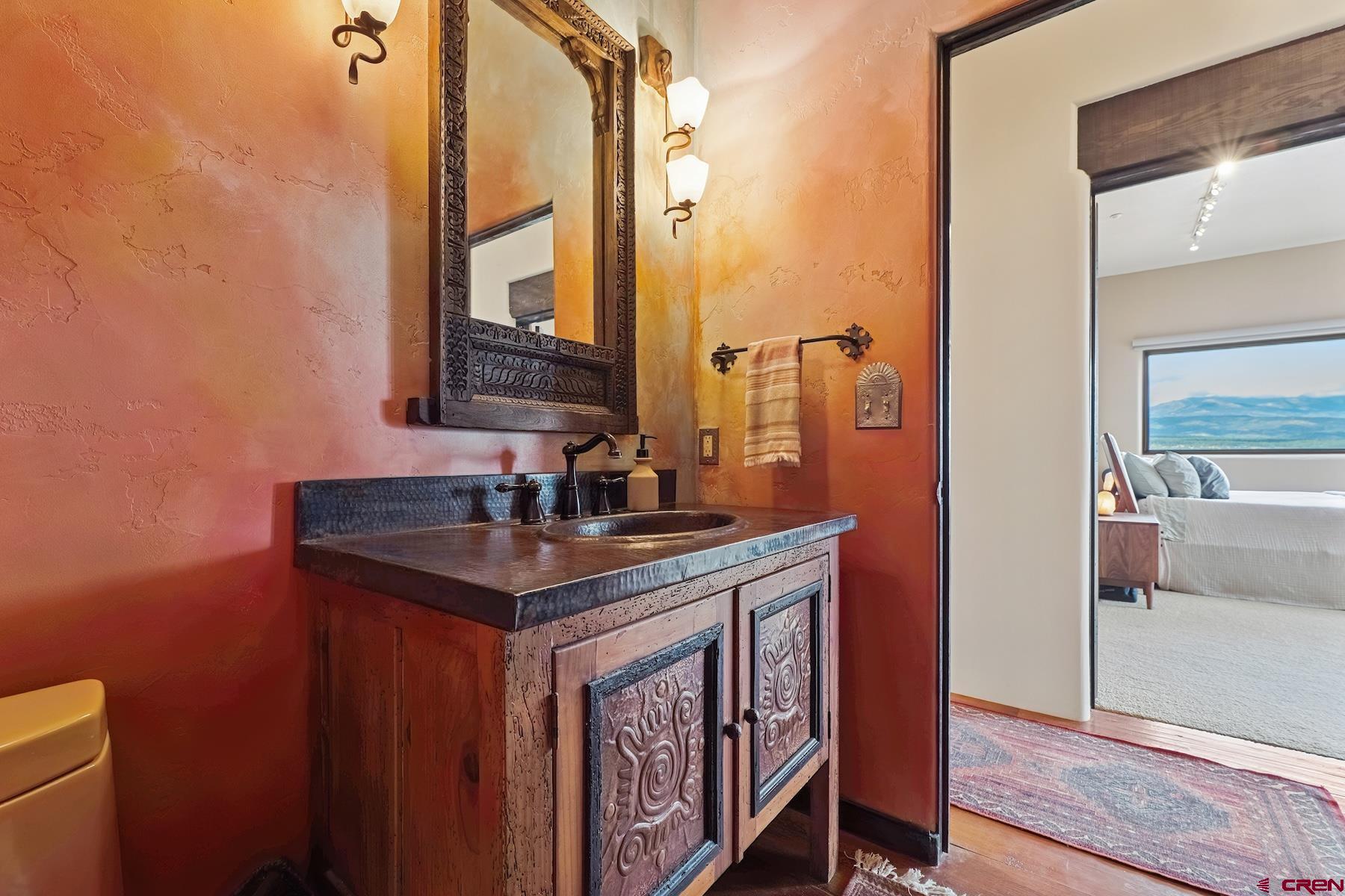 191 Deer Valley Road Hesperus, CO 81326 - Photo 27 of 45 a bathroom with a granite countertop sink a toilet and a mirror