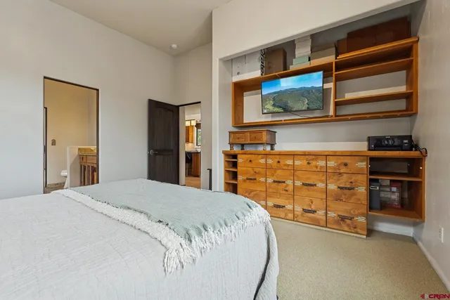 a living room with furniture a window and a flat screen tv