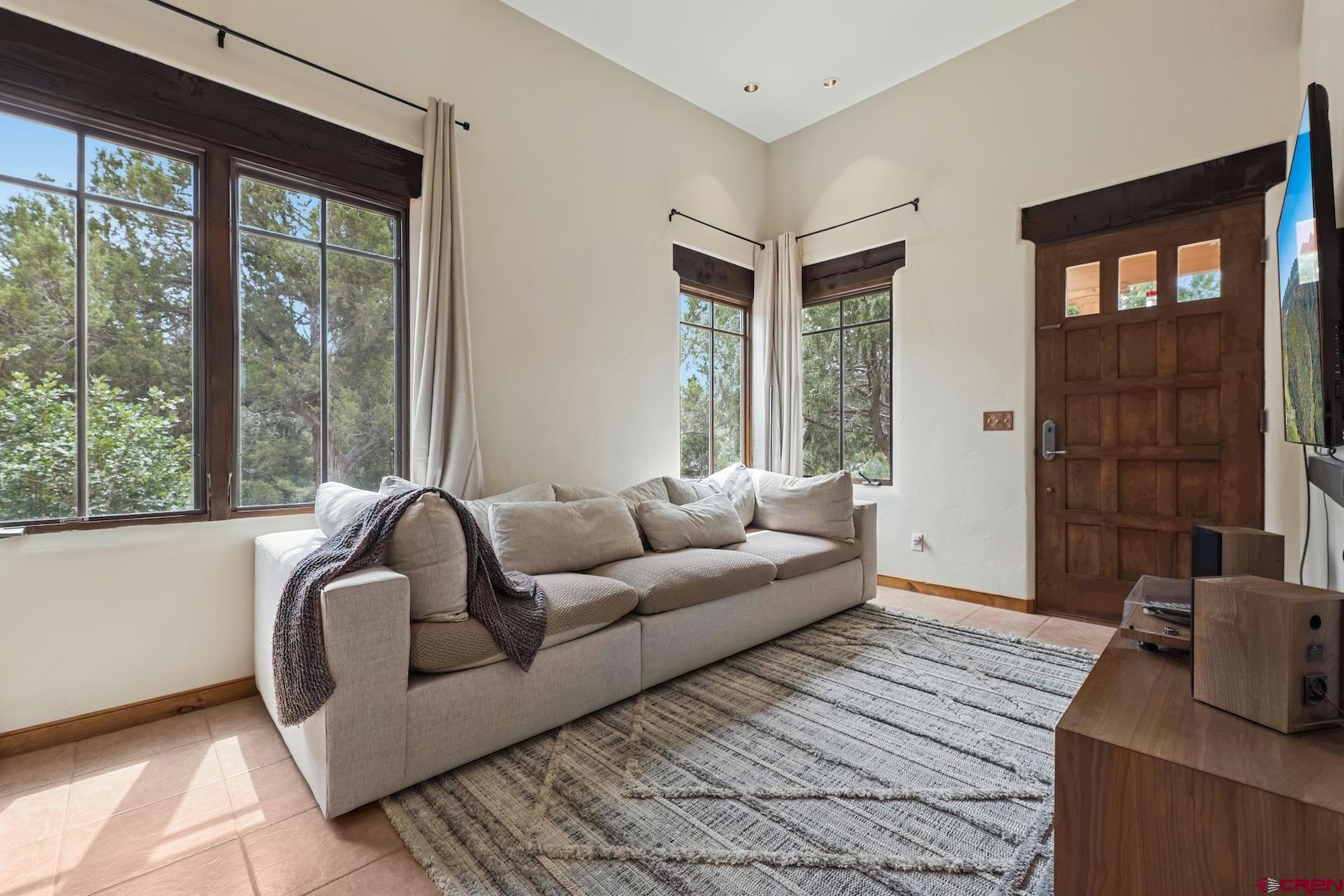 191 Deer Valley Road Hesperus, CO 81326 - Photo 32 of 45 a living room with furniture and a floor to ceiling window