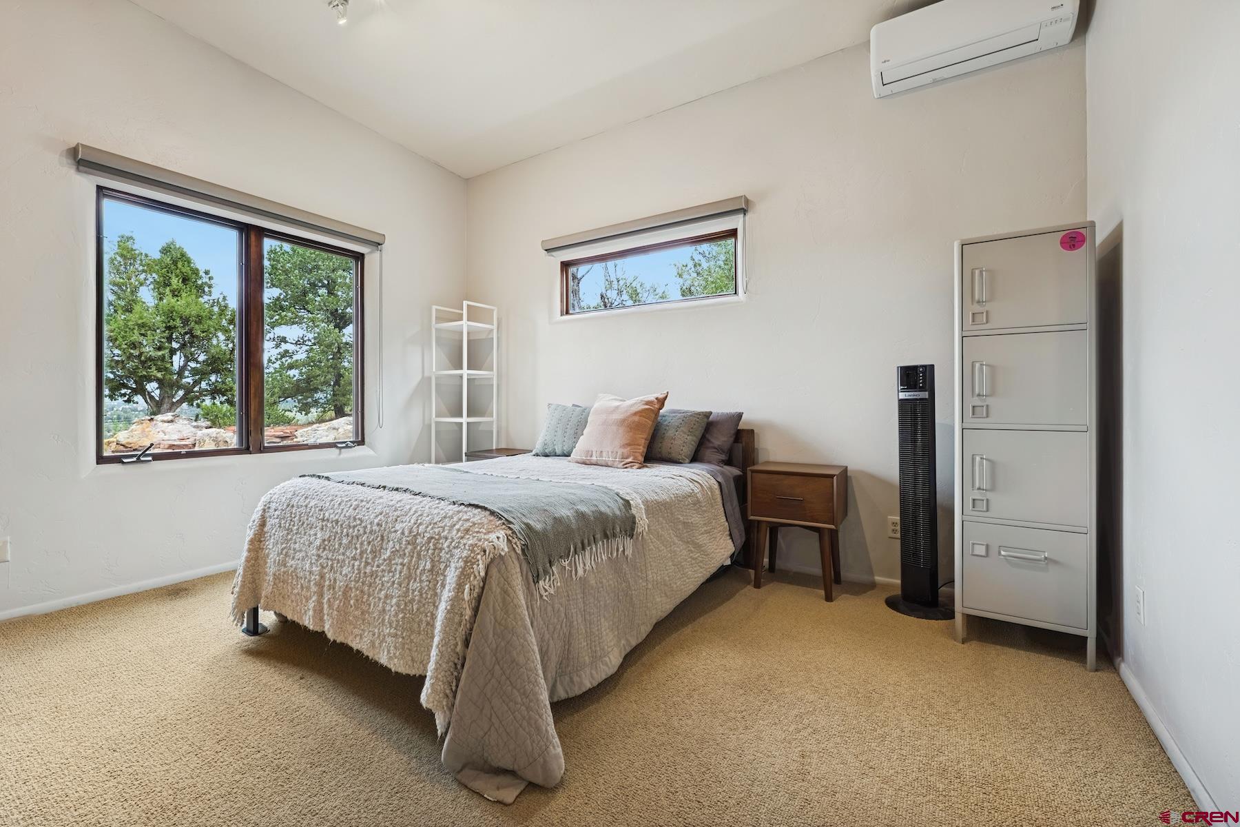 191 Deer Valley Road Hesperus, CO 81326 - Photo 34 of 45 a spacious bedroom with a bed and wooden floor