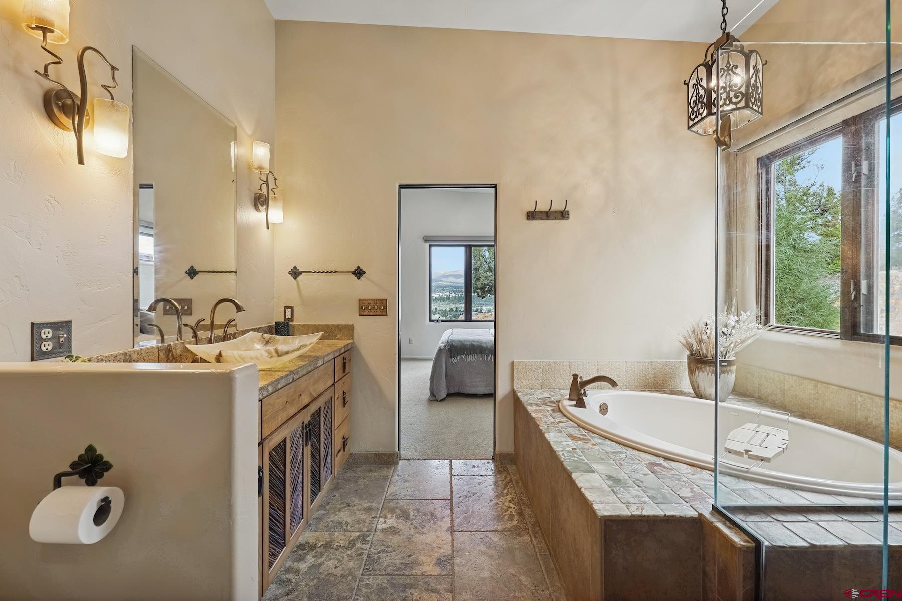 191 Deer Valley Road Hesperus, CO 81326 - Photo 35 of 45 a spacious bathroom with a granite countertop tub sink and mirror