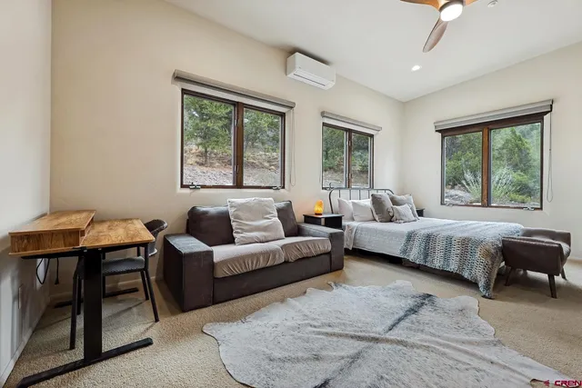 a bedroom with a bed mirror and window