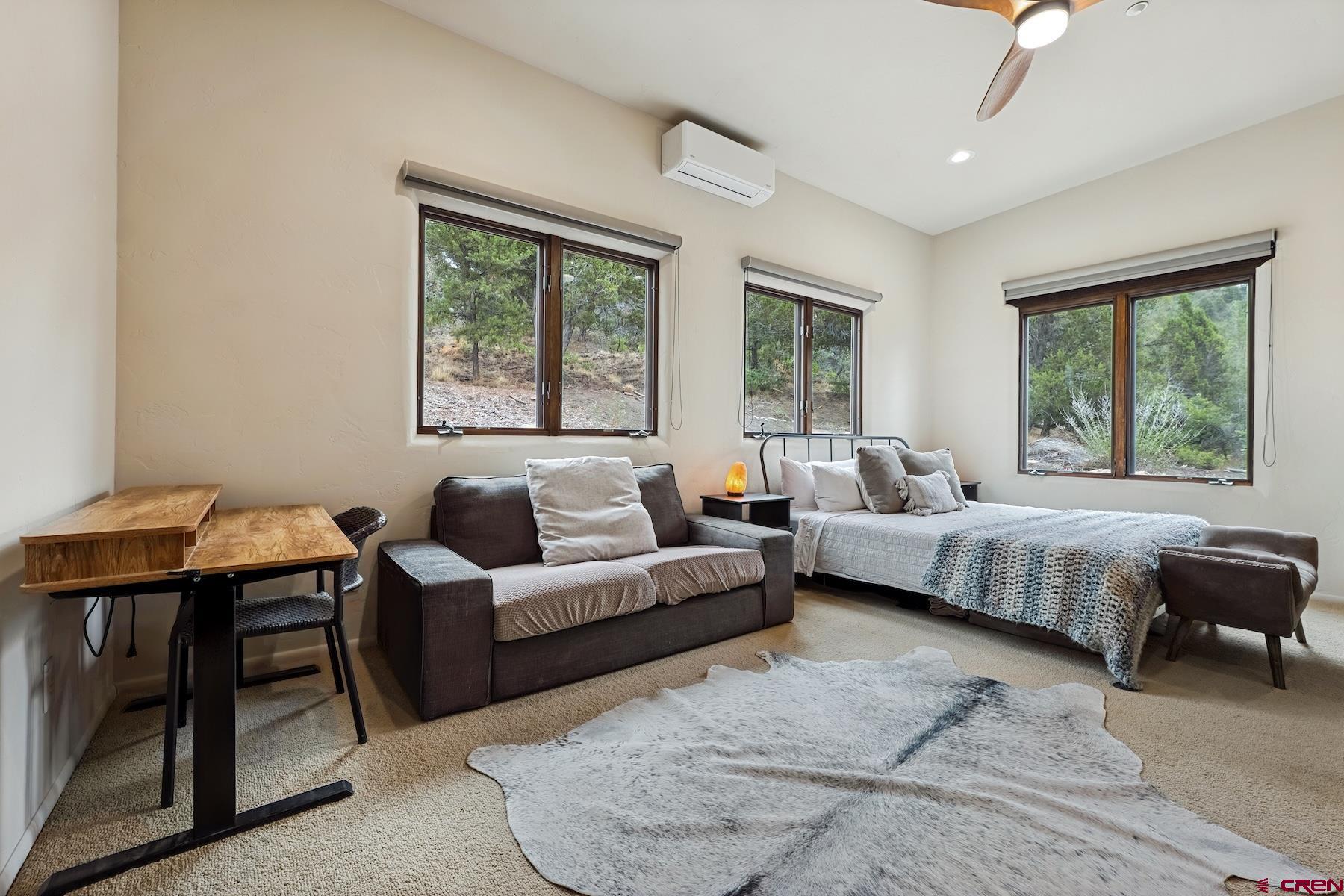 191 Deer Valley Road Hesperus, CO 81326 - Photo 37 of 45 a spacious bedroom with a bed a couch and a window