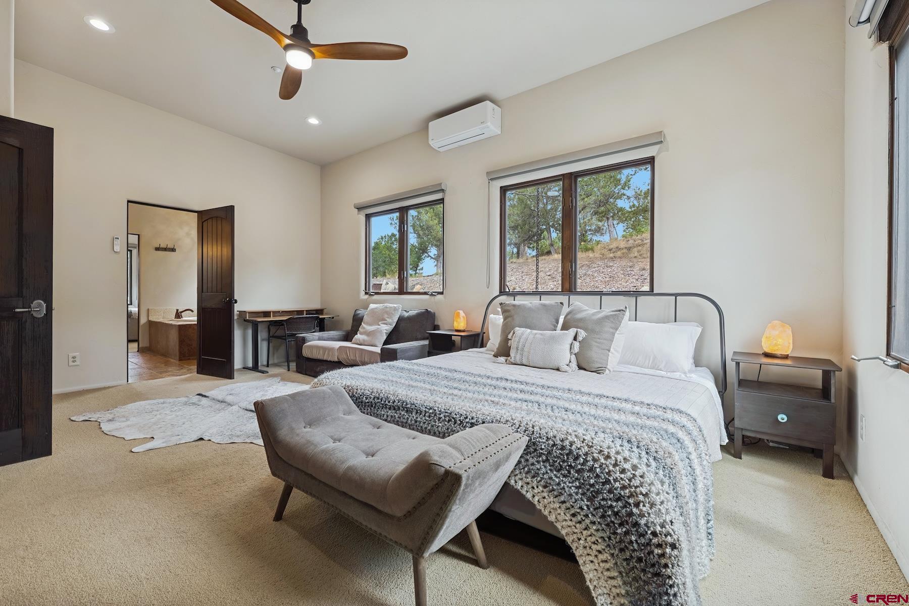 191 Deer Valley Road Hesperus, CO 81326 - Photo 38 of 45 a bedroom with a bed mirror and window