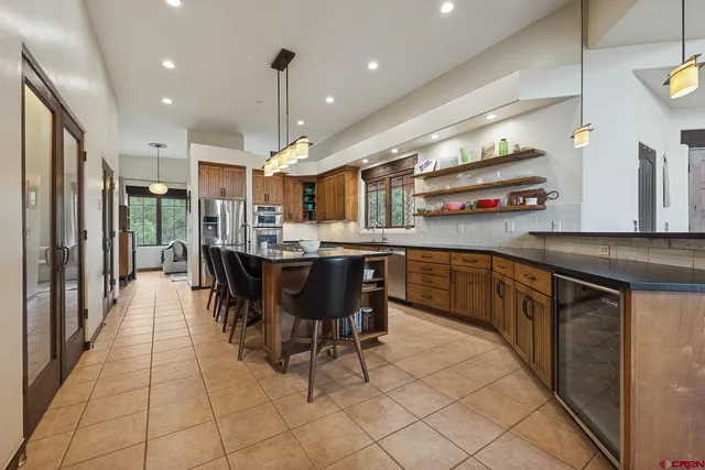 a kitchen with kitchen island granite countertop lots of counter top space and stainless steel appliances