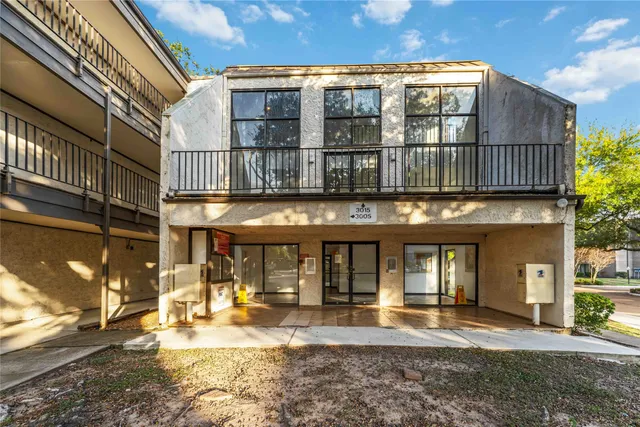 a view of a building with floor to ceiling windows and a rug