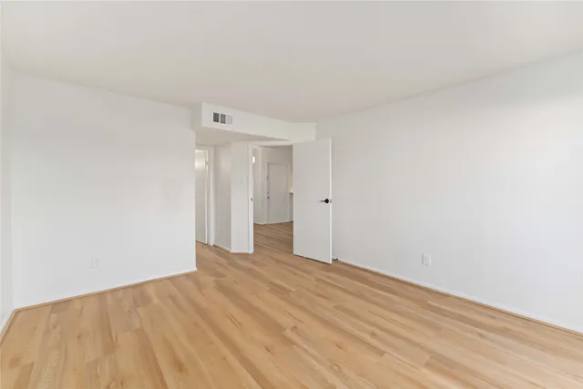 a view of an empty room and wooden floor