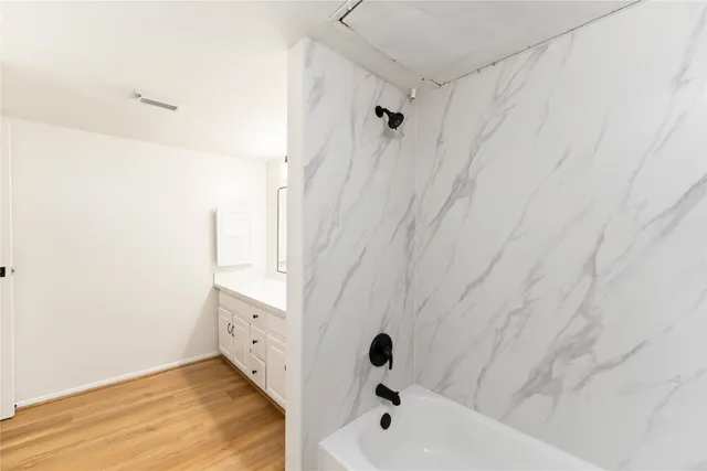 a bathroom with a bathtub and a shower