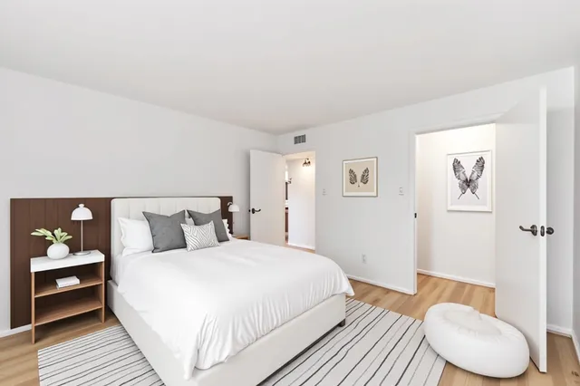 a bedroom with a bed and lamp