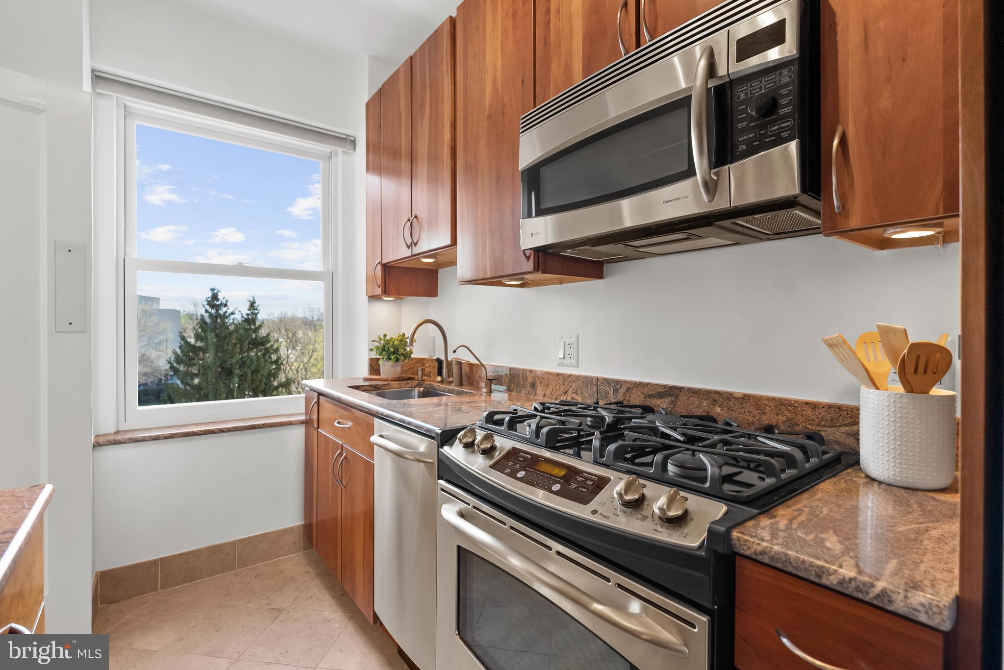 3601 Connecticut Avenue Northwest, Unit 409 Washington, DC 20008 - Photo 15 of 44 a kitchen with stainless steel appliances granite countertop a stove and a microwave