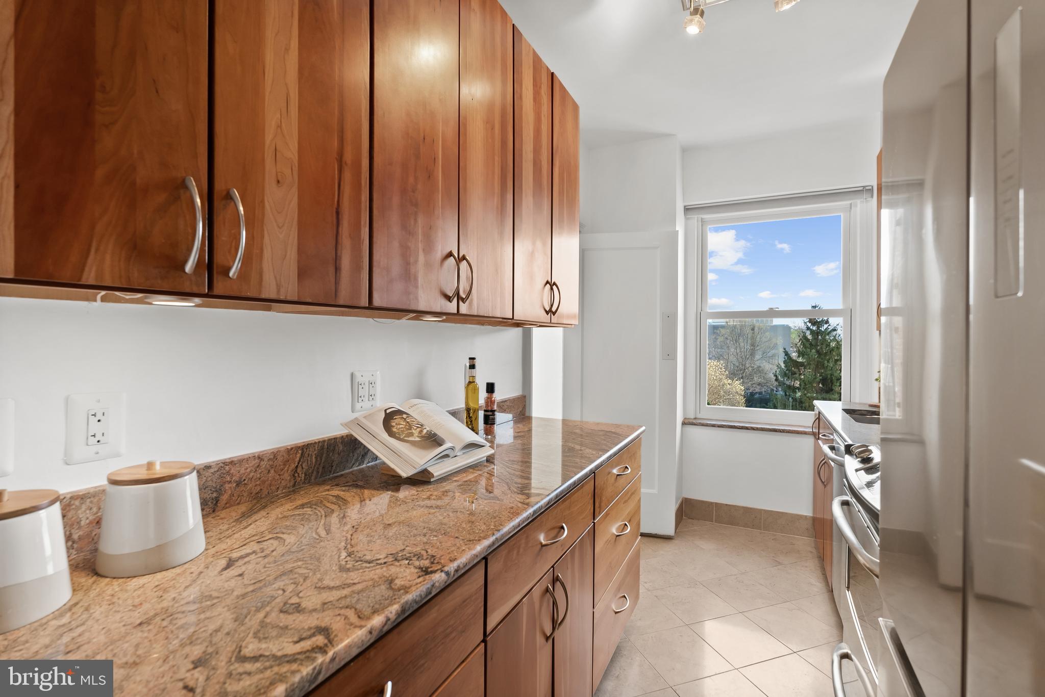 3601 Connecticut Avenue Northwest, Unit 409 Washington, DC 20008 - Photo 16 of 44 a kitchen with a sink and wooden cabinets