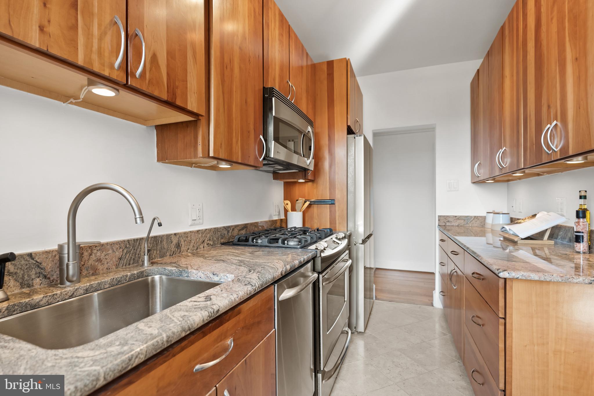 3601 Connecticut Avenue Northwest, Unit 409 Washington, DC 20008 - Photo 17 of 44 a kitchen with stainless steel appliances granite countertop a sink stove and cabinets