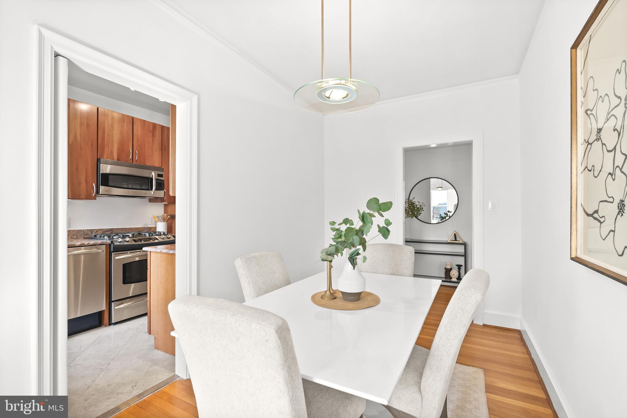 3601 Connecticut Avenue Northwest, Unit 409 Washington, DC 20008 - Photo 19 of 44 a view of a dining room with furniture and wooden floor