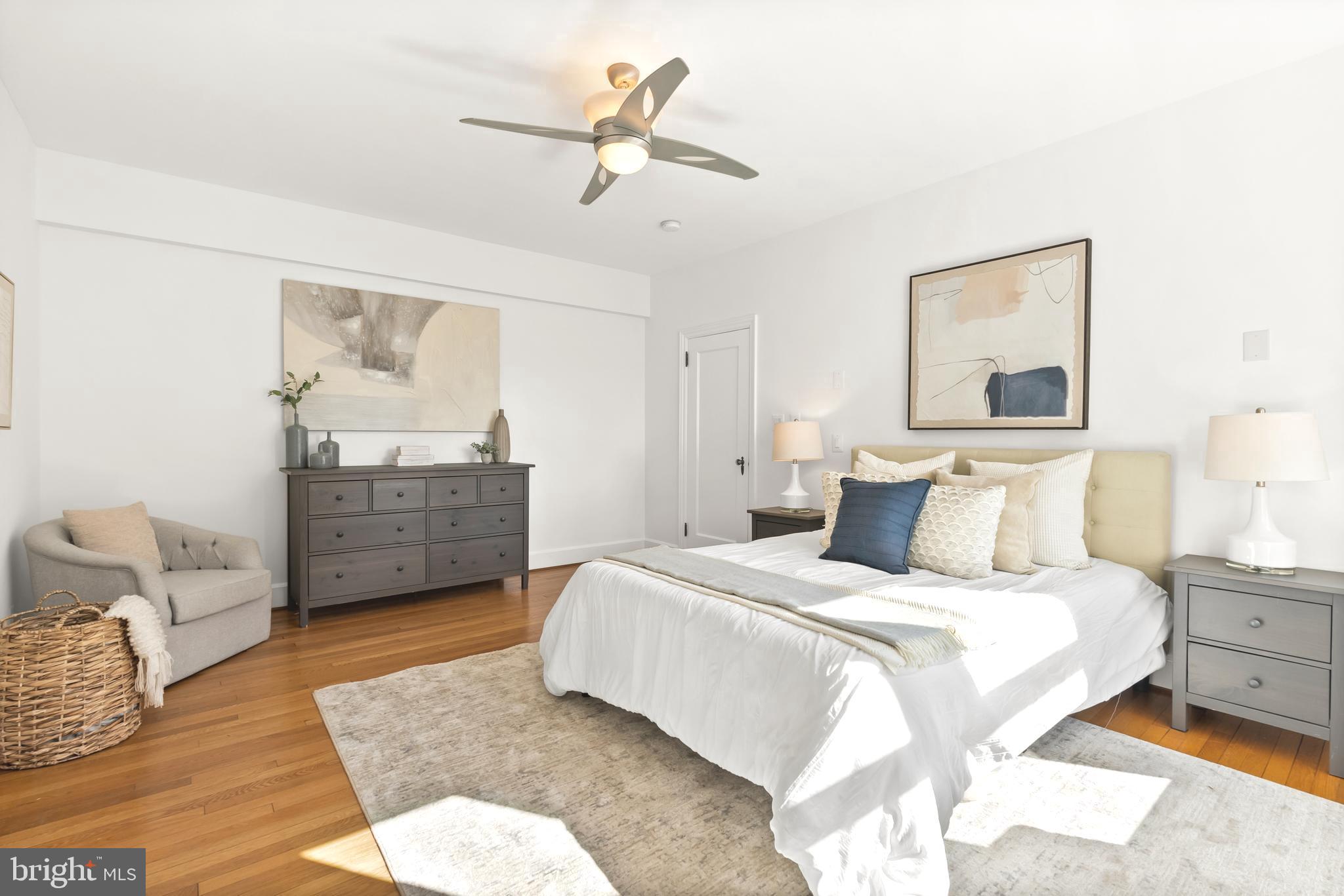 3601 Connecticut Avenue Northwest, Unit 409 Washington, DC 20008 - Photo 22 of 44 a bedroom with a bed dresser and wooden floor