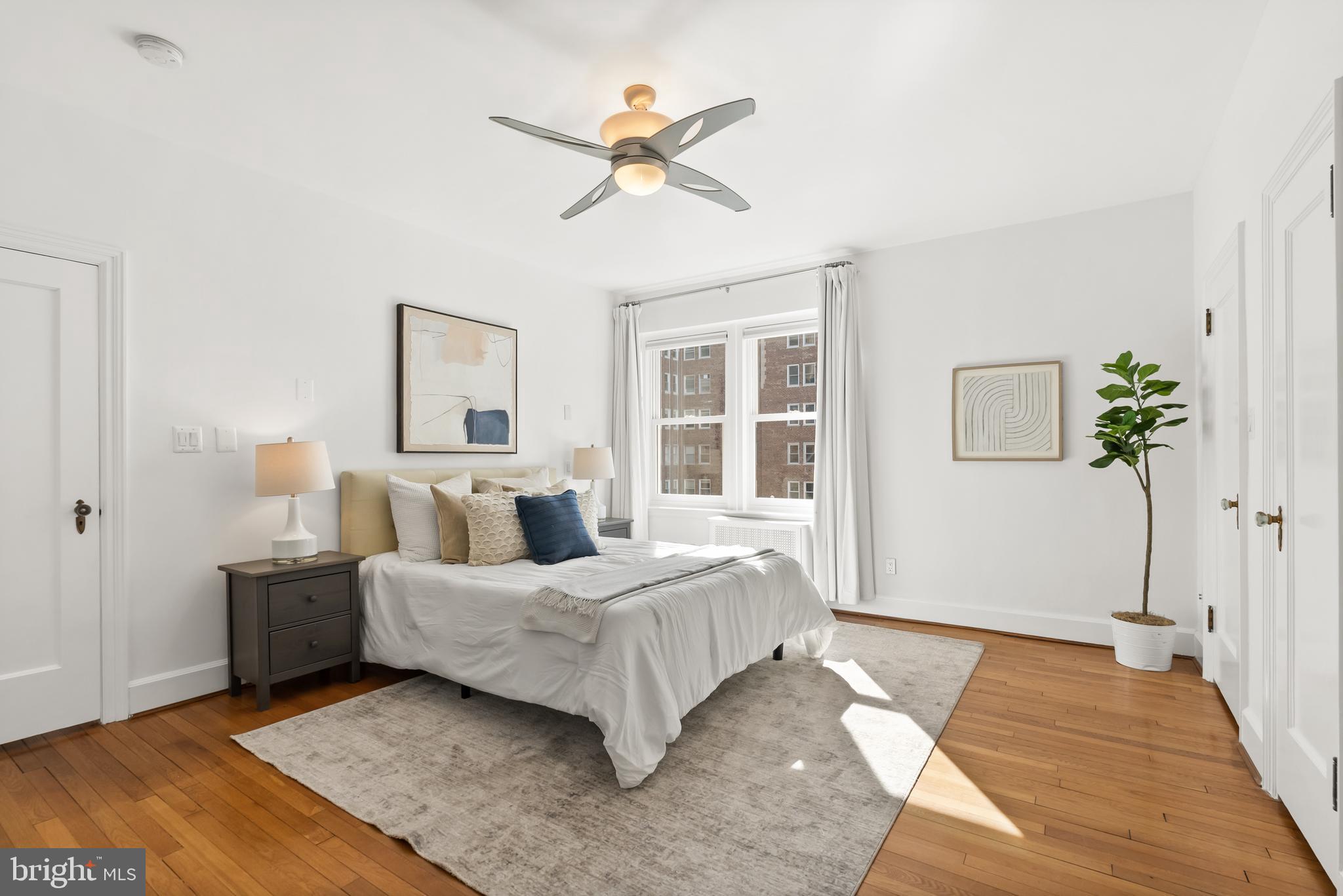 3601 Connecticut Avenue Northwest, Unit 409 Washington, DC 20008 - Photo 24 of 44 a bedroom with a large bed and a chandelier