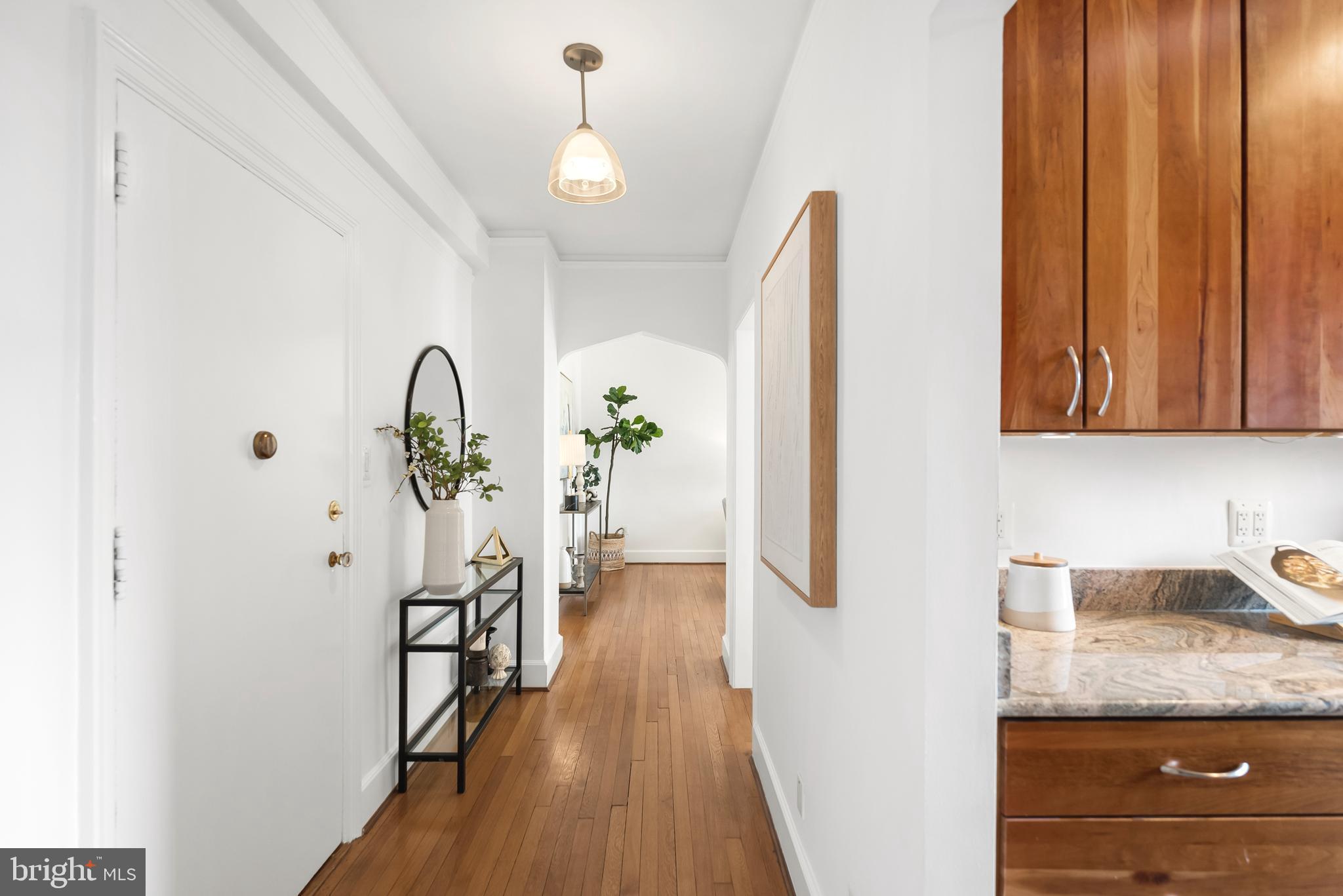 3601 Connecticut Avenue Northwest, Unit 409 Washington, DC 20008 - Photo 6 of 44 a hallway with sliding door and wooden floor