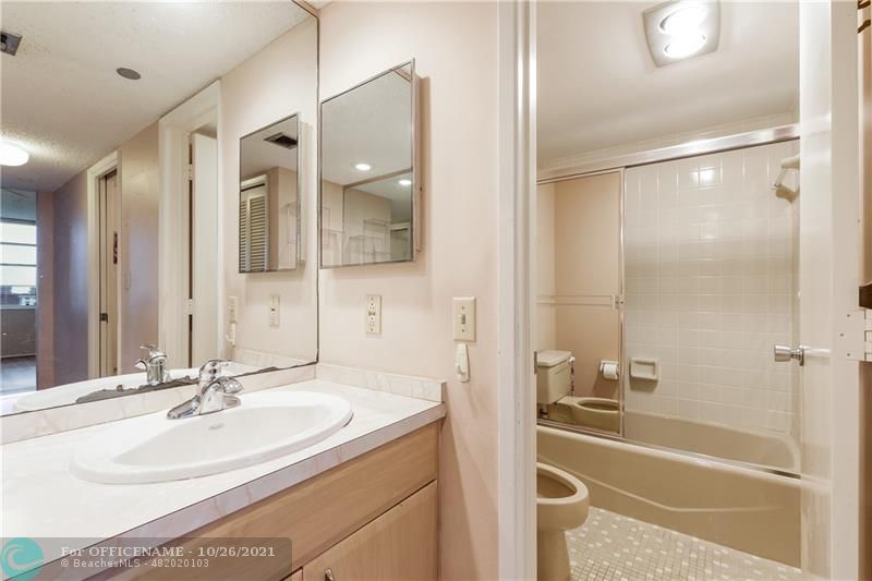 3520 Oaks Way, Unit 607 Pompano Beach, FL 33069 - Photo 13 of 31 a bathroom with a bathtub and a sink
