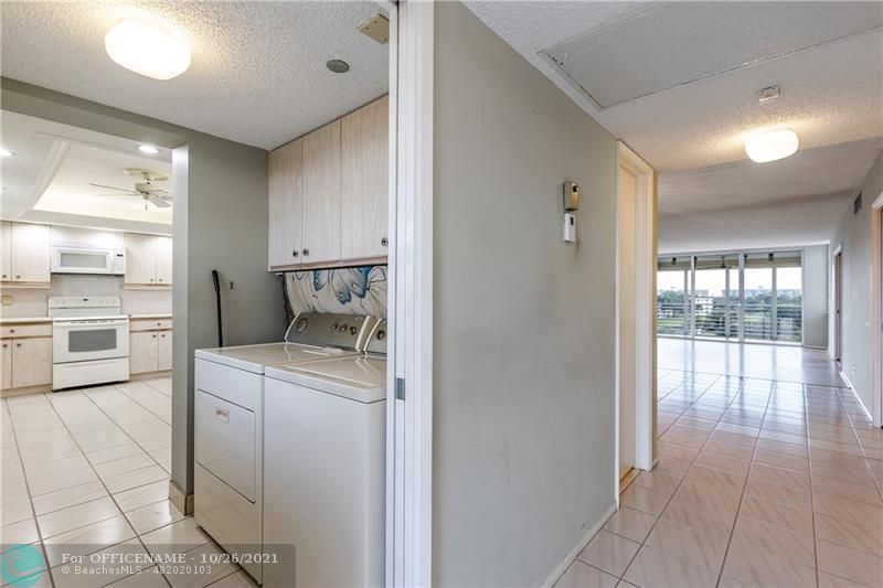 3520 Oaks Way, Unit 607 Pompano Beach, FL 33069 - Photo 14 of 31 a room with a washer and dryer