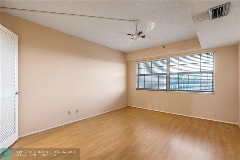 3520 Oaks Way, Unit 607 Pompano Beach, FL 33069 - Photo 17 of 31 a view of an empty room with a window
