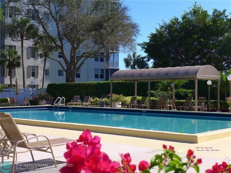 3520 Oaks Way, Unit 607 Pompano Beach, FL 33069 - Photo 22 of 31 a view of a swimming pool with a patio