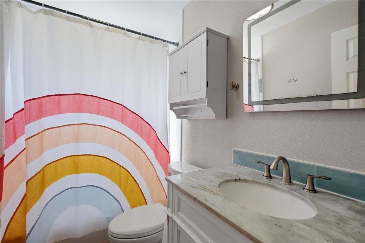 204 Queen Road St. Augustine, FL 32086 - Photo 26 of 55 Bathroom with curtained shower, a textured wall, and vanity
