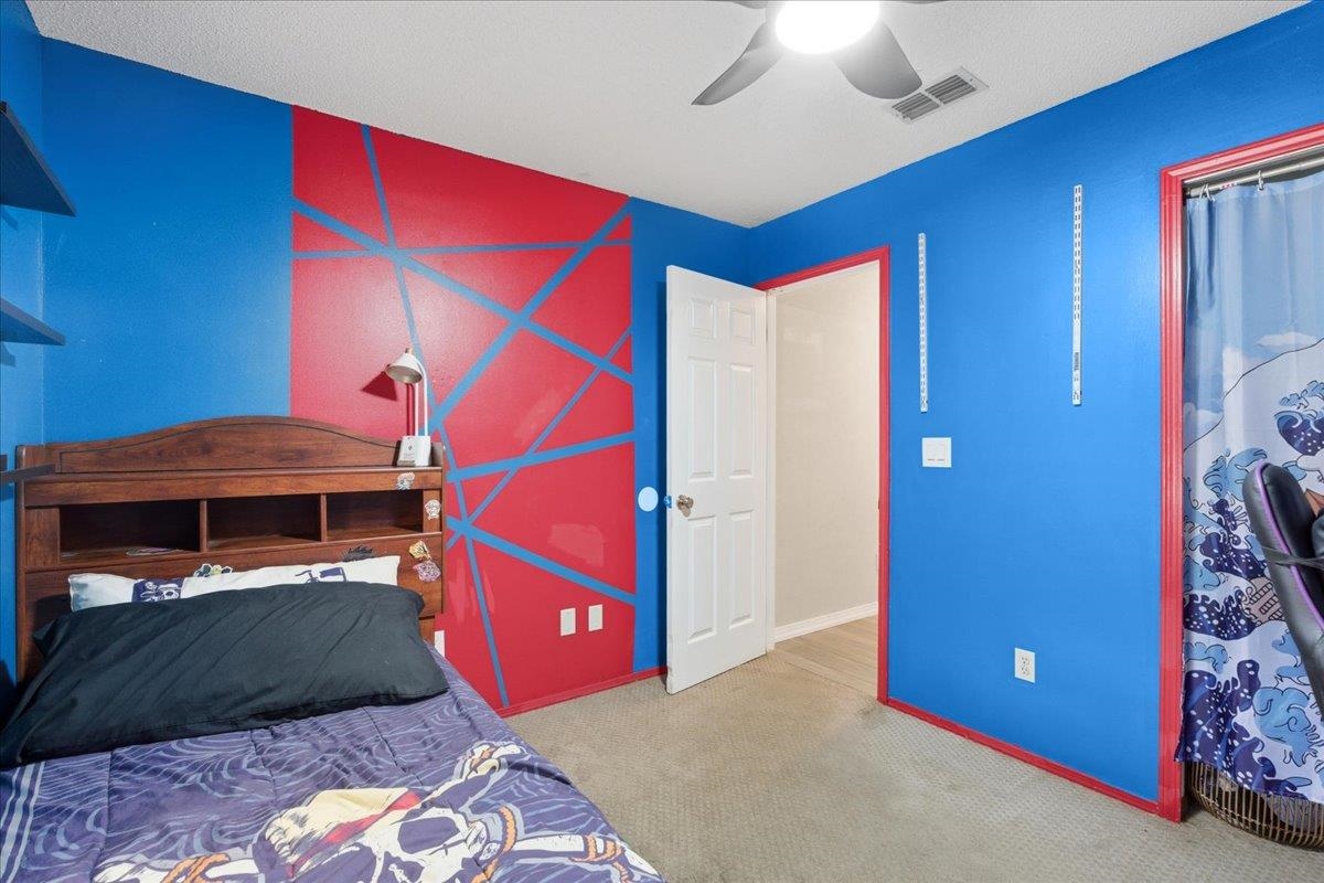 204 Queen Road St. Augustine, FL 32086 - Photo 28 of 55 Bedroom with light carpet and ceiling fan