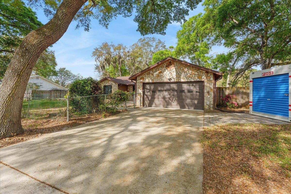 204 Queen Road St. Augustine, FL 32086 - Photo 3 of 55 Ranch-style house with stone siding, driveway, and an attached garage