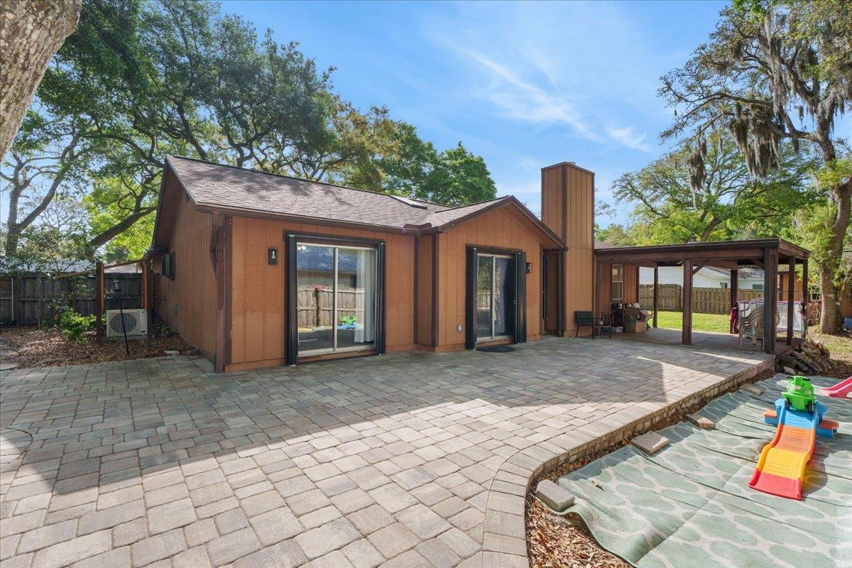 204 Queen Road St. Augustine, FL 32086 - Photo 34 of 55 Rear view of property featuring a patio and a chimney