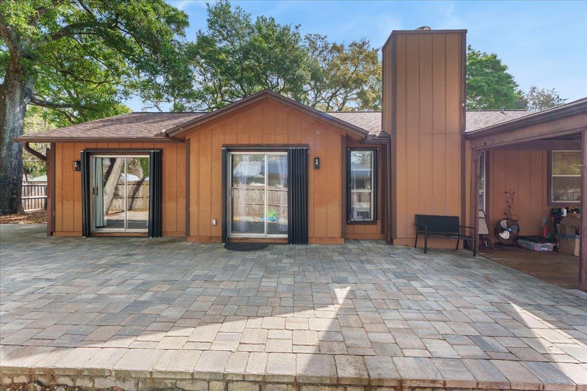 204 Queen Road St. Augustine, FL 32086 - Photo 35 of 55 Back of property featuring a chimney, a patio, and roof with shingles