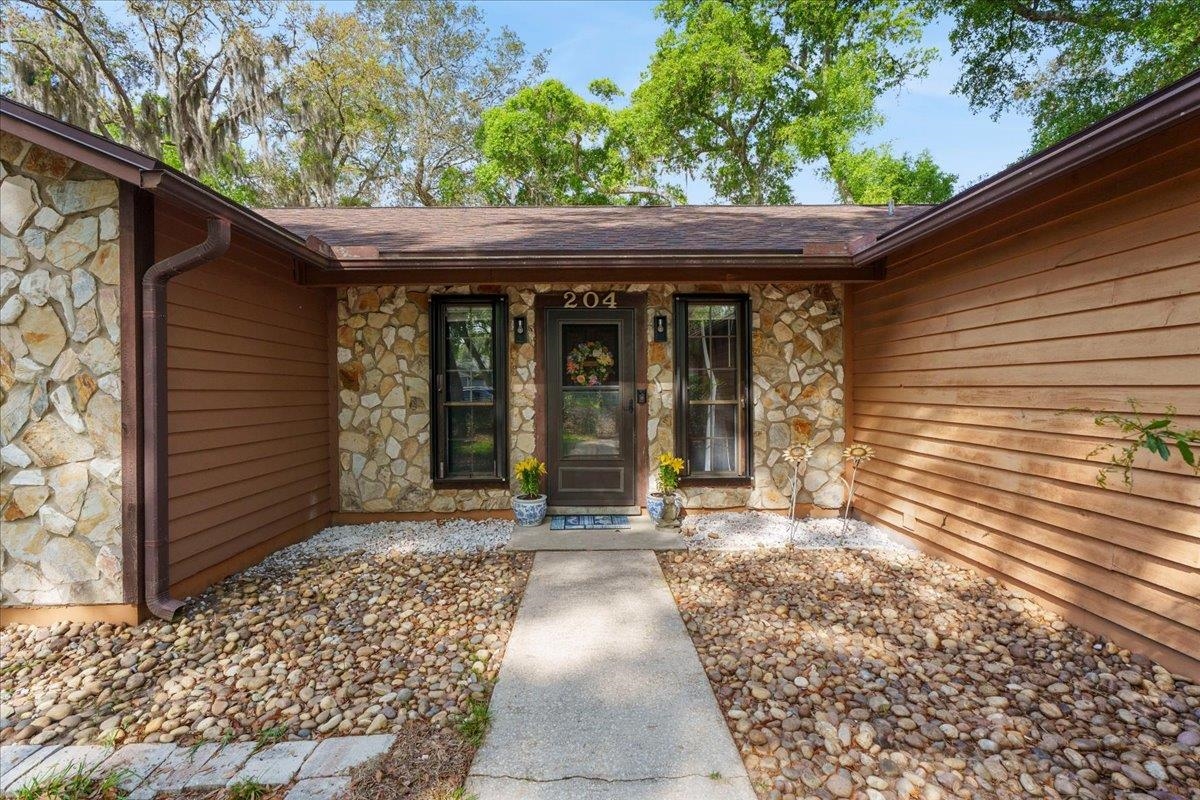 204 Queen Road St. Augustine, FL 32086 - Photo 6 of 55 Entrance to property featuring stone siding and covered porch