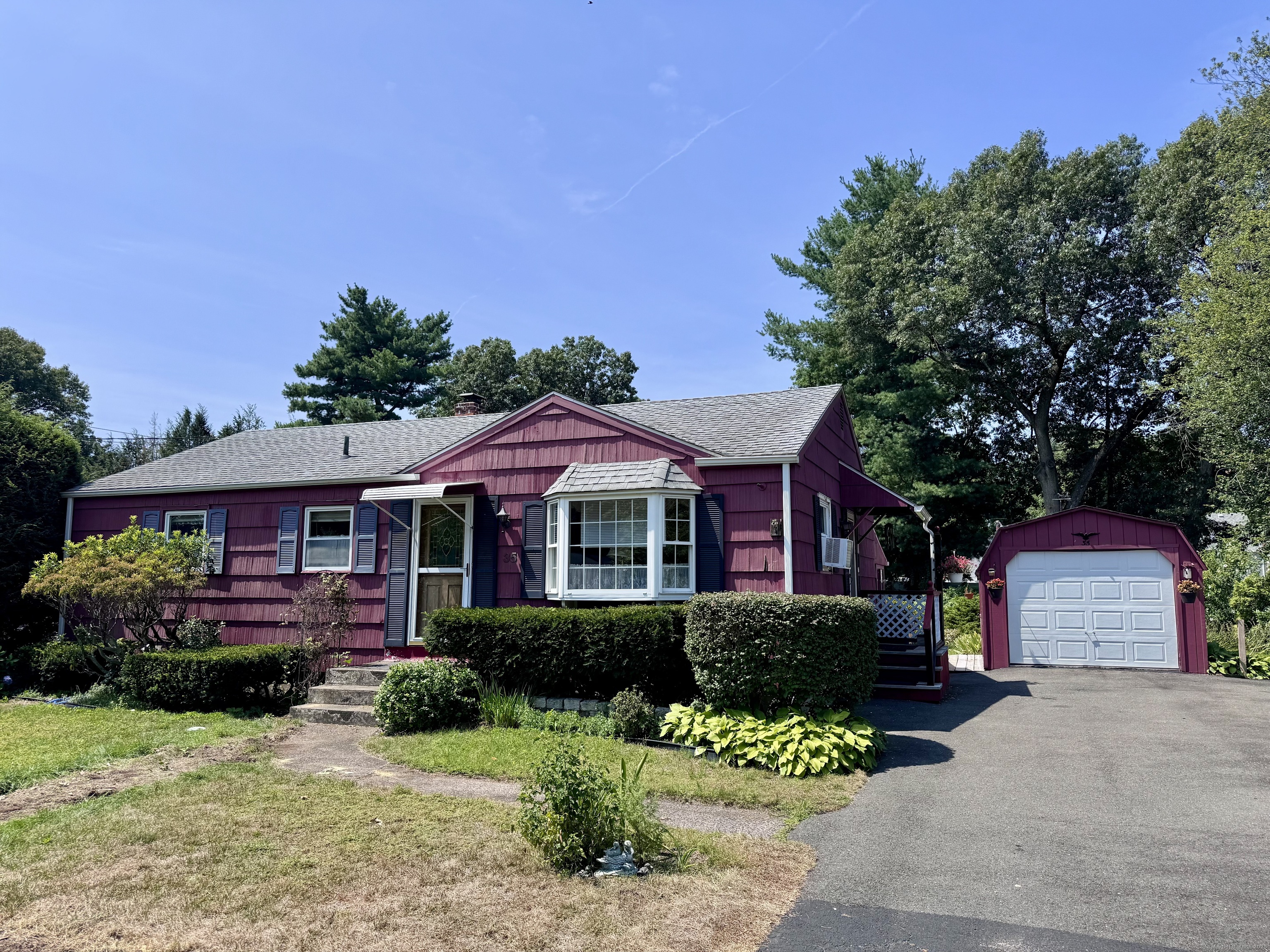 a front view of a house with a yard and a garage