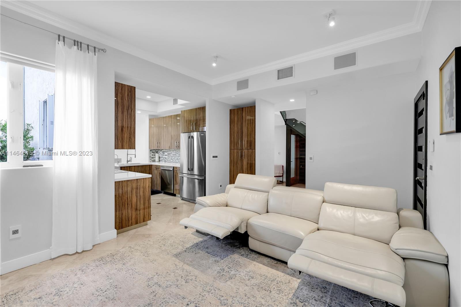 3015 Northeast 208th Street, Unit 3015 Aventura, FL 33180 - Photo 20 of 53 a living room with furniture and a large window