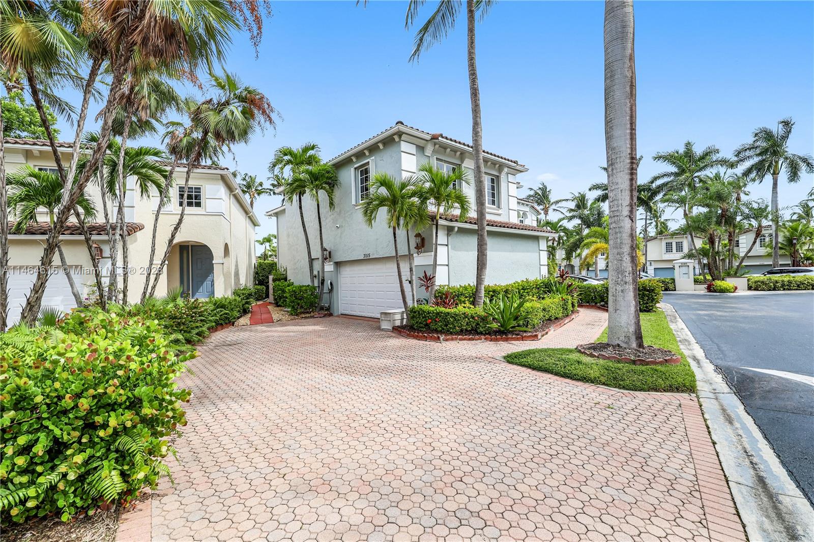 3015 Northeast 208th Street, Unit 3015 Aventura, FL 33180 - Photo 2 of 53 a front view of a house with garden and plants