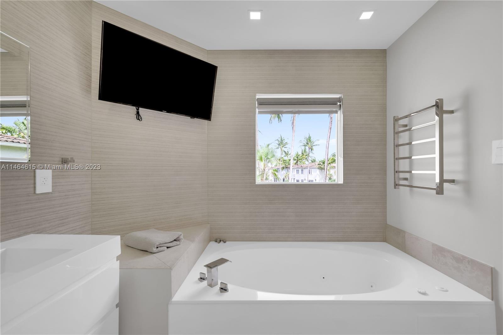 3015 Northeast 208th Street, Unit 3015 Aventura, FL 33180 - Photo 29 of 53 a bathroom with a bathtub and a flat screen tv