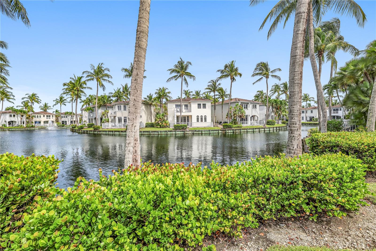 3015 Northeast 208th Street, Unit 3015 Aventura, FL 33180 - Photo 47 of 53 a view of a lake with palm trees