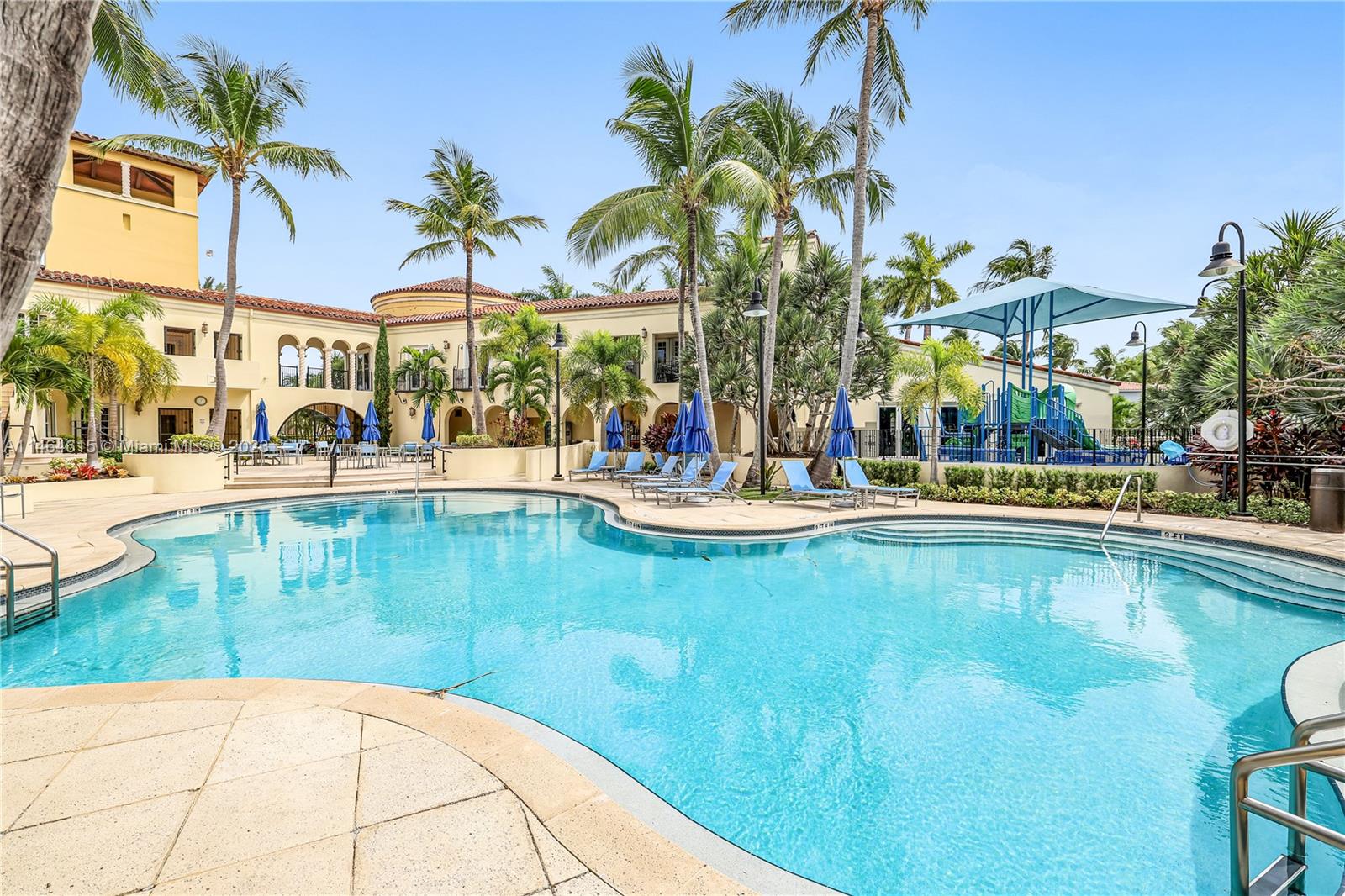 3015 Northeast 208th Street, Unit 3015 Aventura, FL 33180 - Photo 51 of 53 a swimming pool with outdoor seating and yard