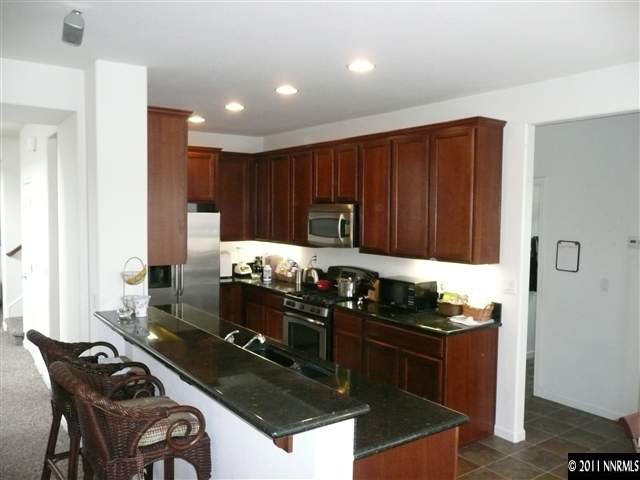 460 Sysonby Court Reno, NV 89521 - Photo 4 of 8 a kitchen with granite countertop a stove sink and cabinets